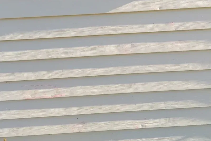 Hail damage to aluminum siding.